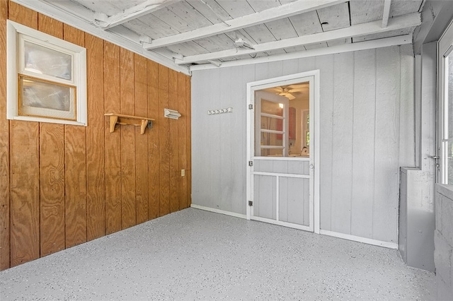 unfurnished room with wooden walls