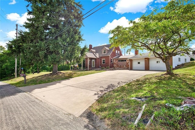 view of front of home with a front lawn and a garage