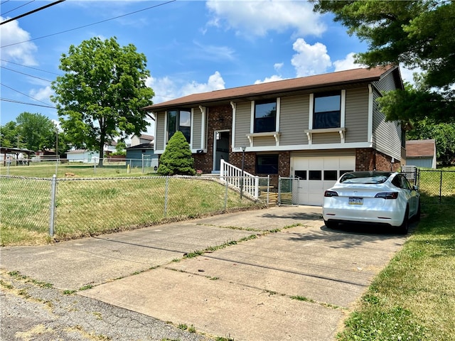 bi-level home featuring a garage and a front yard