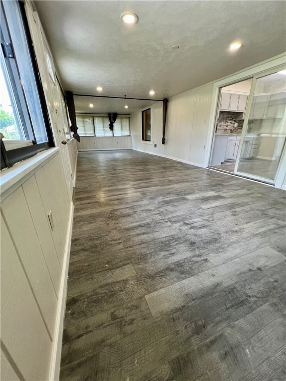 unfurnished living room with dark hardwood / wood-style flooring