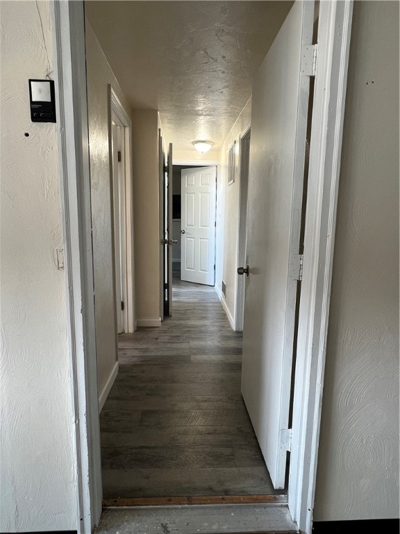 hallway with dark hardwood / wood-style floors