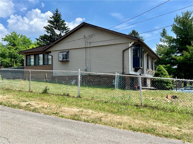 view of side of home with a yard