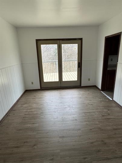 unfurnished room with dark wood-type flooring