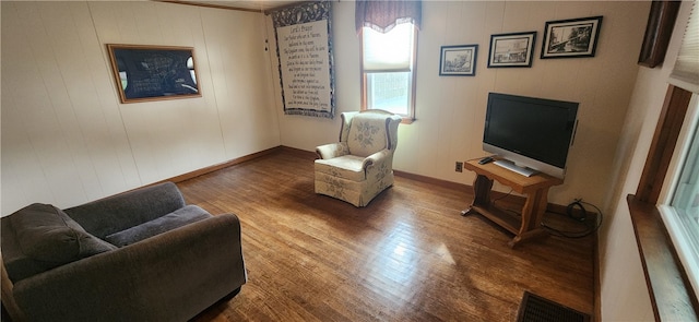 living area with hardwood / wood-style flooring