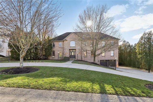 view of front of house featuring a front yard and a garage