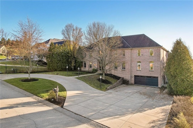 view of front of property with a front yard and a garage