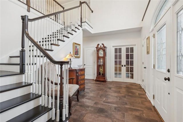 entrance foyer with a wealth of natural light, french doors, and dark wood-type flooring