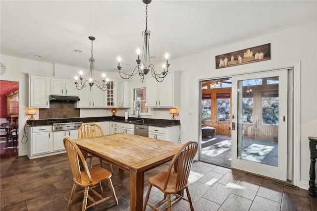 kitchen featuring french doors, sink, stainless steel appliances, decorative light fixtures, and white cabinets