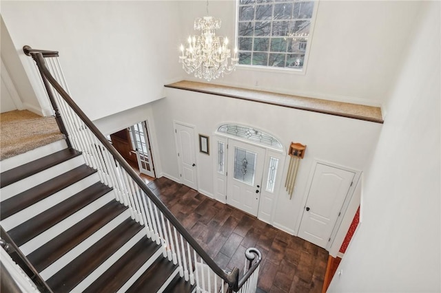 foyer with a chandelier and dark wood-type flooring