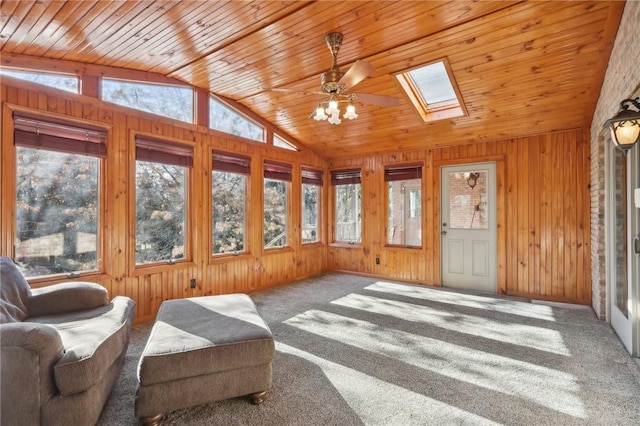 sunroom with ceiling fan, vaulted ceiling with skylight, and wooden ceiling