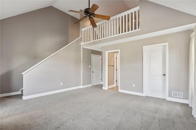 unfurnished living room with carpet, high vaulted ceiling, and ceiling fan