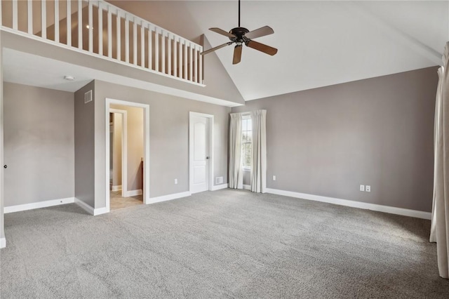 interior space featuring carpet, connected bathroom, ceiling fan, and high vaulted ceiling