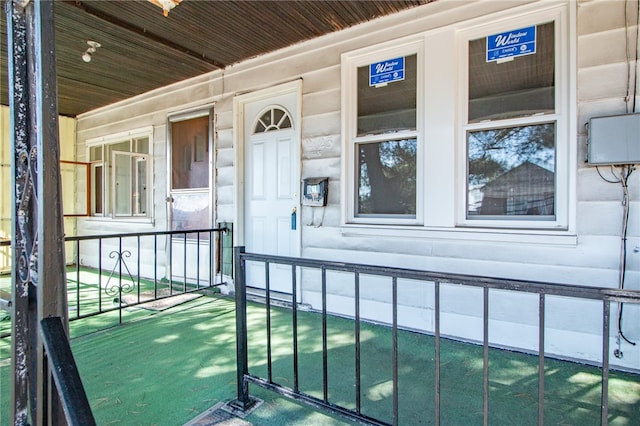 view of exterior entry with covered porch