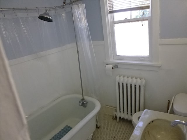 bathroom with tile patterned floors, radiator heating unit, shower / tub combo with curtain, and toilet