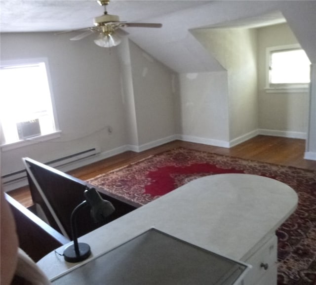 additional living space featuring ceiling fan and hardwood / wood-style flooring