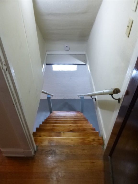 staircase featuring dark hardwood / wood-style floors