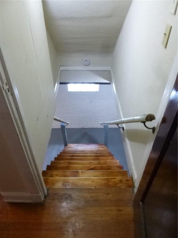 staircase featuring wood finished floors