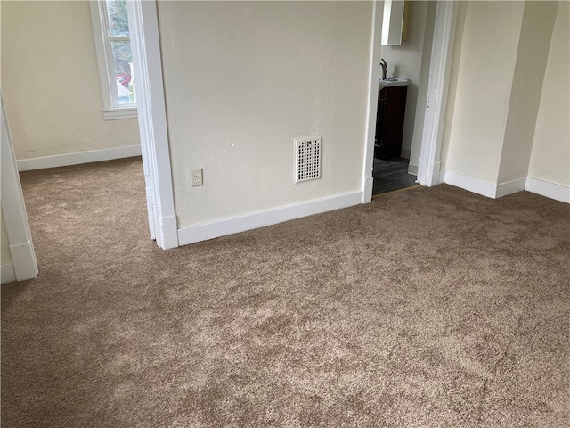 empty room featuring dark colored carpet