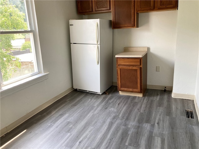 kitchen with hardwood / wood-style flooring and white refrigerator