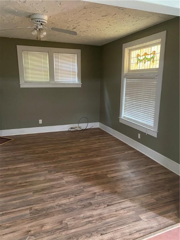 empty room featuring a textured ceiling, ceiling fan, and hardwood / wood-style flooring