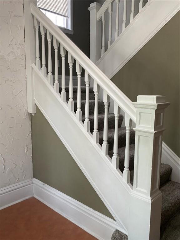 staircase featuring wood-type flooring