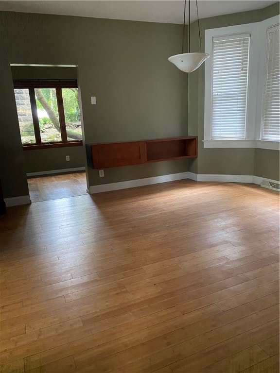 empty room with hardwood / wood-style floors