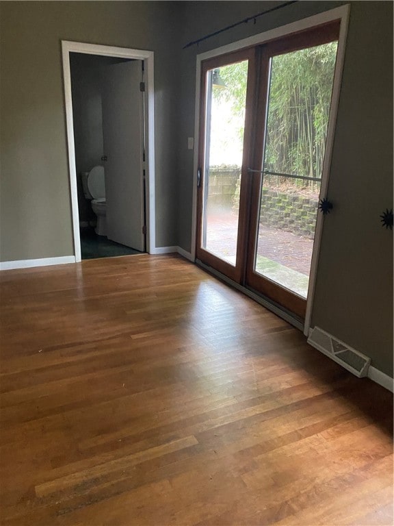 unfurnished room with wood-type flooring