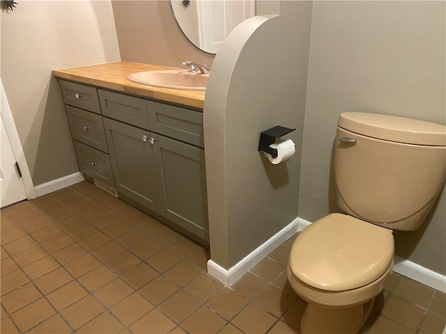 bathroom featuring vanity, toilet, and tile patterned floors