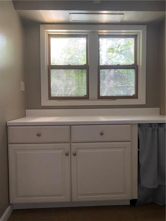 interior space featuring plenty of natural light, white cabinetry, and dishwasher