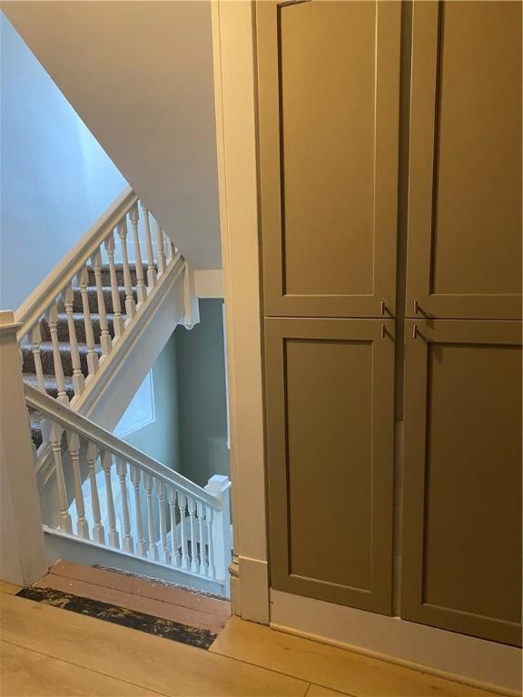 stairway with hardwood / wood-style floors