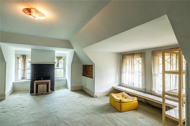 bonus room featuring carpet floors, a fireplace, and vaulted ceiling