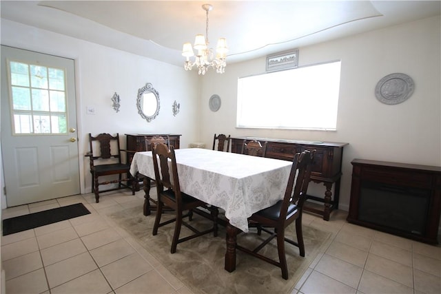 dining room with light tile patterned flooring and a chandelier