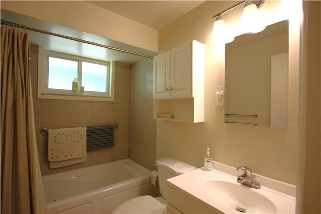 full bathroom featuring shower / bathtub combination with curtain, vanity, and toilet