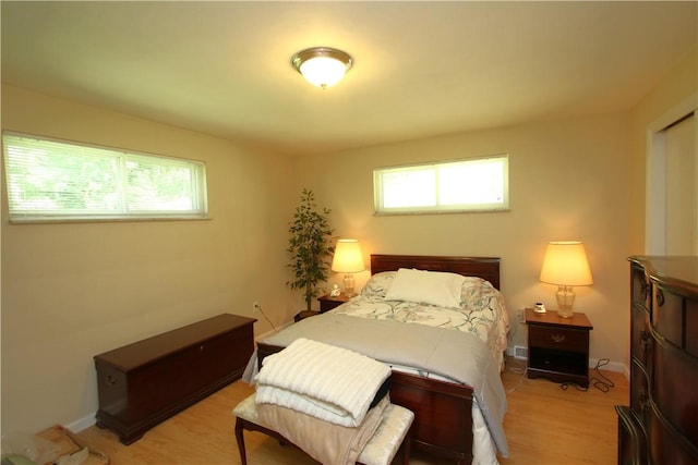 bedroom featuring light hardwood / wood-style flooring and multiple windows