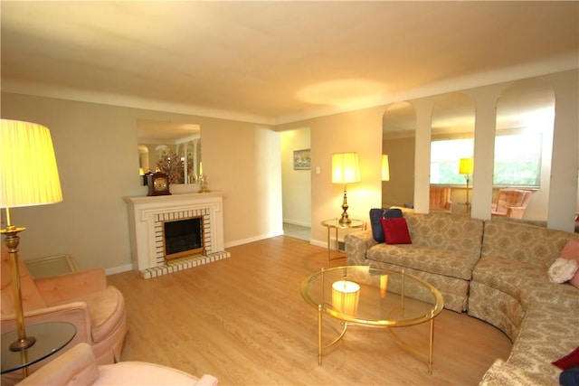 living room with wood-type flooring and a fireplace