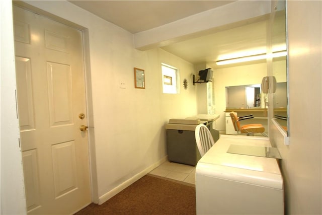 laundry area featuring light tile patterned floors and separate washer and dryer