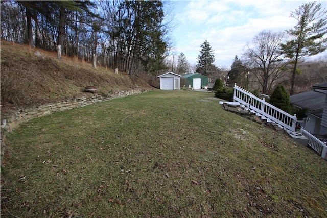 view of yard with a garage and a storage shed