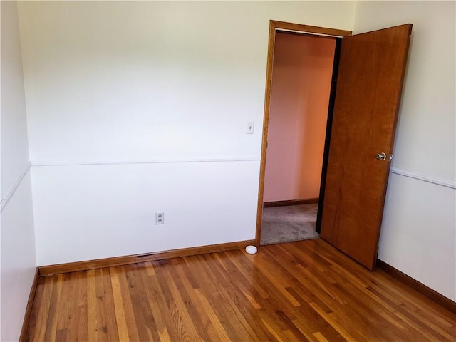 empty room with hardwood / wood-style floors