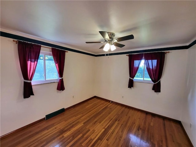 unfurnished room featuring hardwood / wood-style flooring, ceiling fan, and crown molding