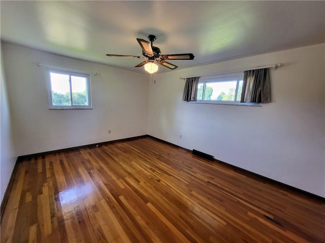 empty room featuring wood-type flooring and ceiling fan