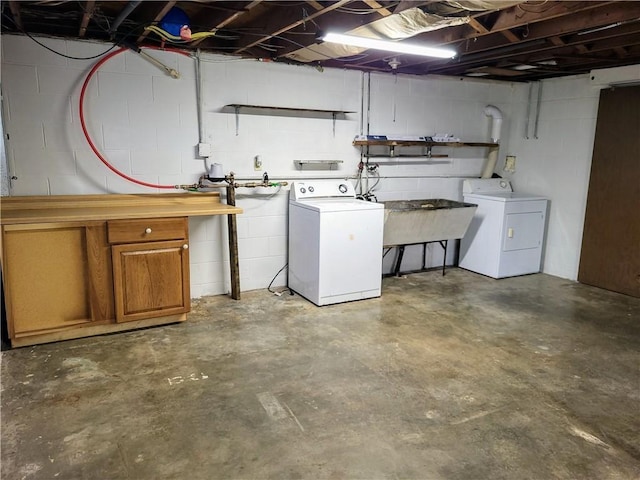 basement with sink and independent washer and dryer