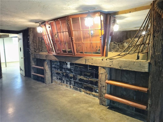 basement featuring a textured ceiling