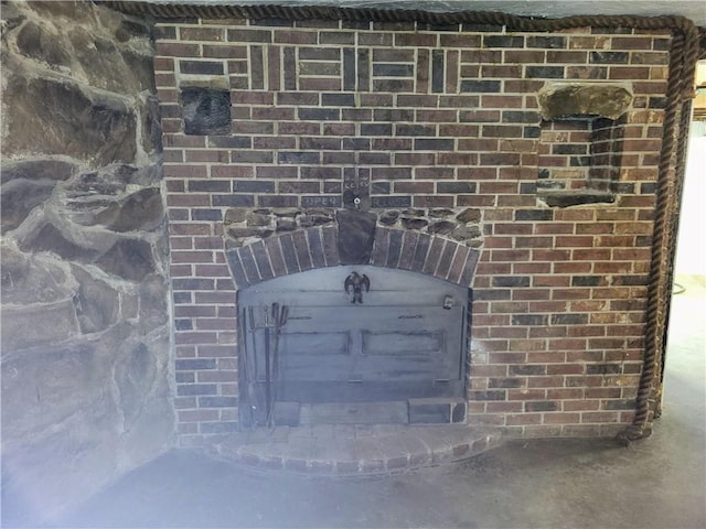 details with concrete floors and a wood stove