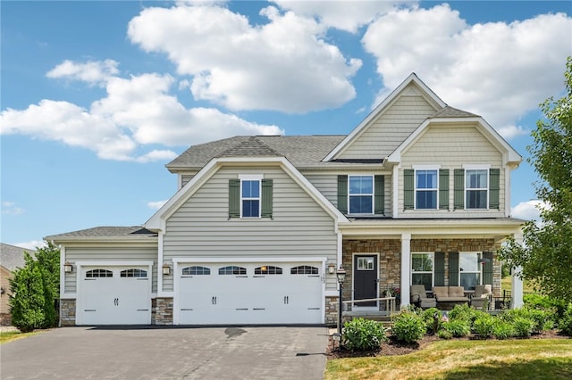 craftsman-style home with a garage and covered porch