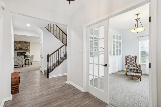 interior space featuring hardwood / wood-style flooring, a fireplace, and french doors