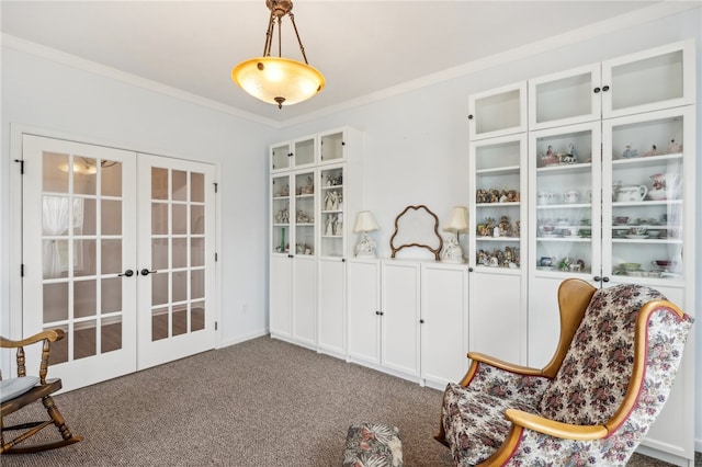 living area featuring carpet floors, french doors, and ornamental molding