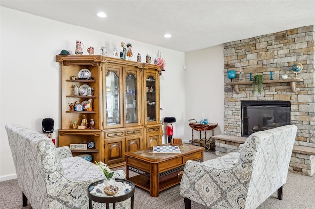 sitting room featuring a fireplace and light carpet