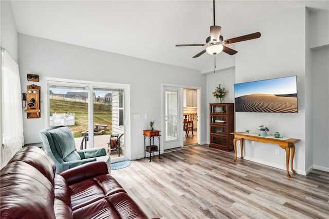 living room with hardwood / wood-style flooring, high vaulted ceiling, and ceiling fan