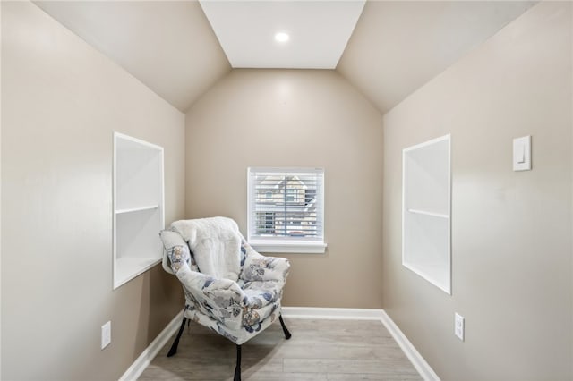 living area featuring light hardwood / wood-style floors and lofted ceiling