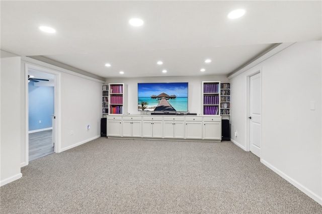 unfurnished living room featuring light carpet and ceiling fan